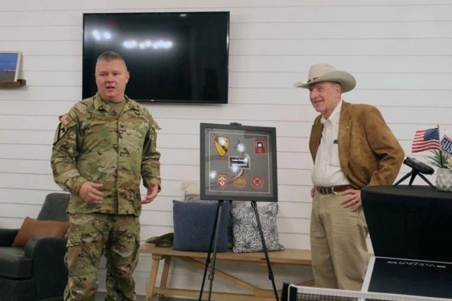 Col Chad R Foster stands with Gordan Logan Sport Clips founder