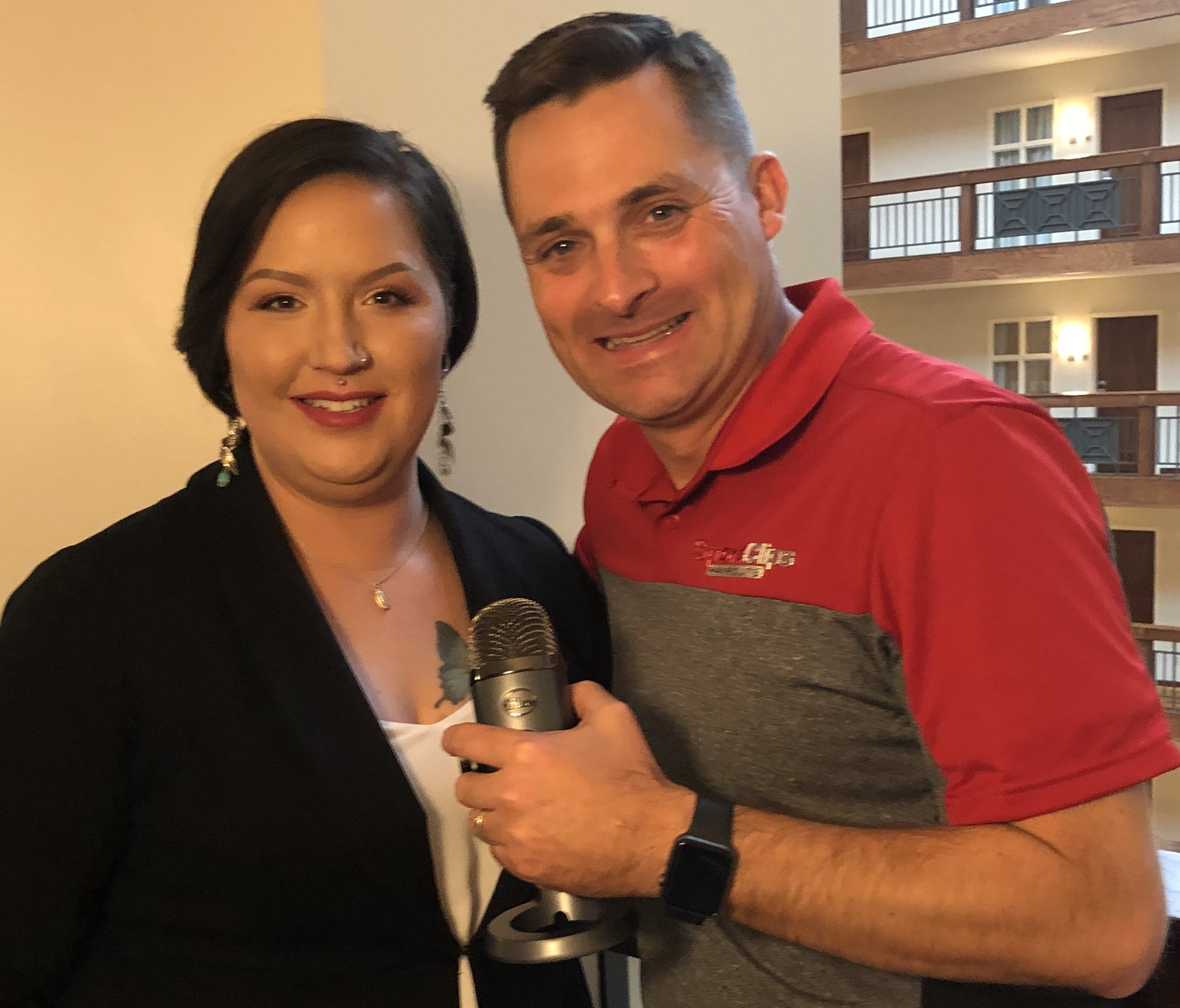 Chad Jordan and Colleen Foster holding a microphone