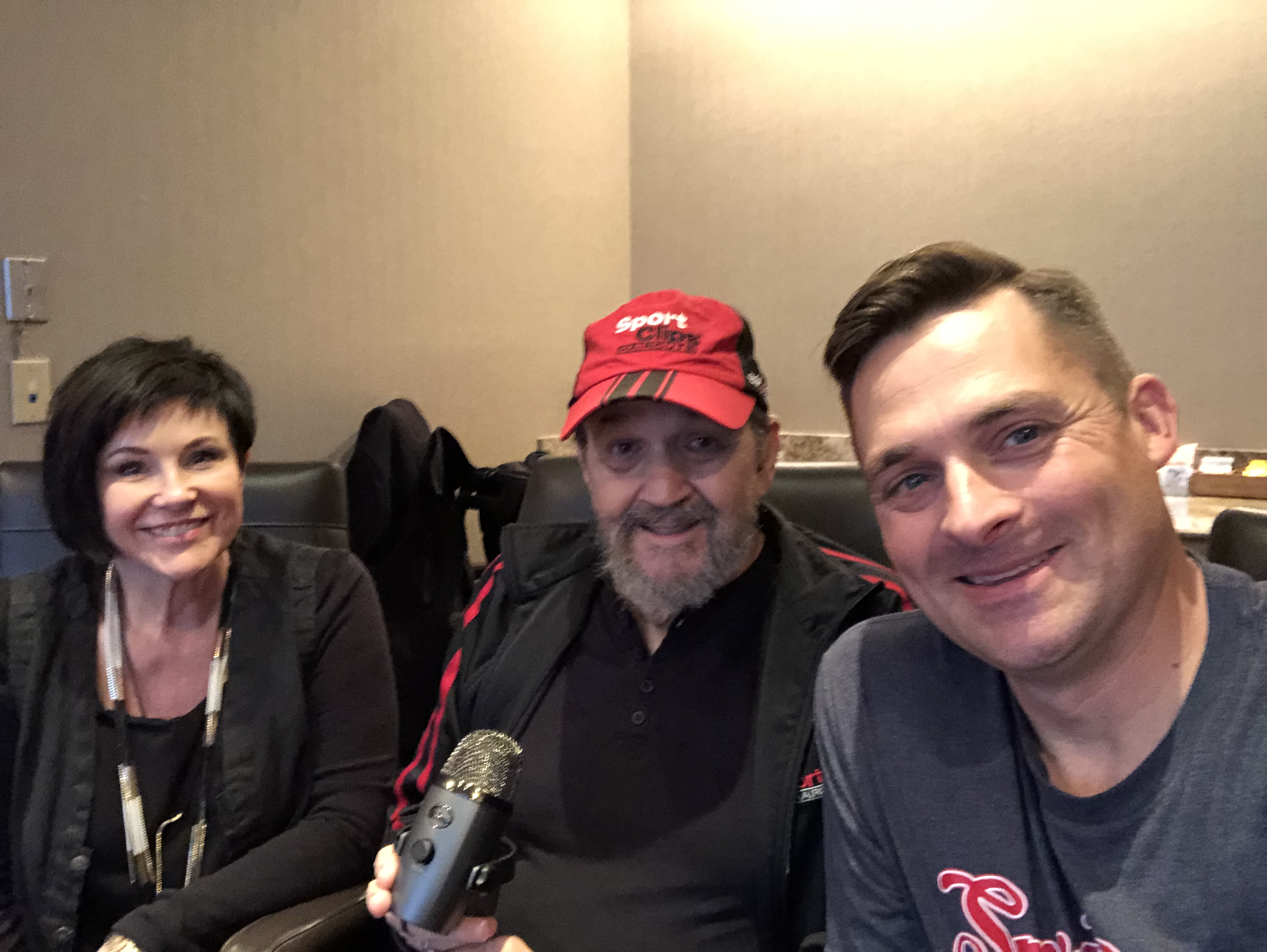 Chad Jordan, Tommy Callahan and Ramona Callahan holding a microphone