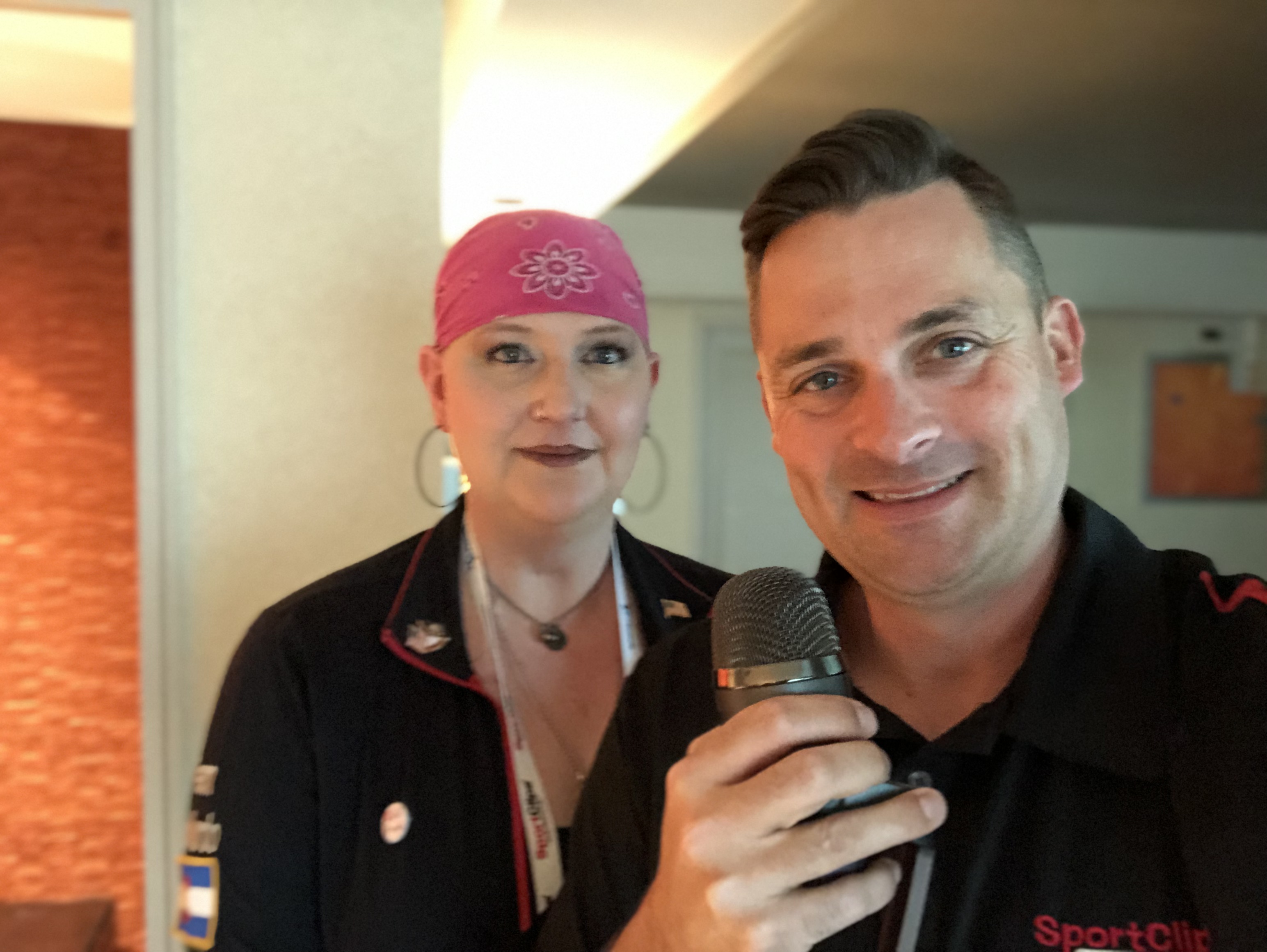 Chad Jordan holding a microphone and Kriss Sparks wearing a pink bandana