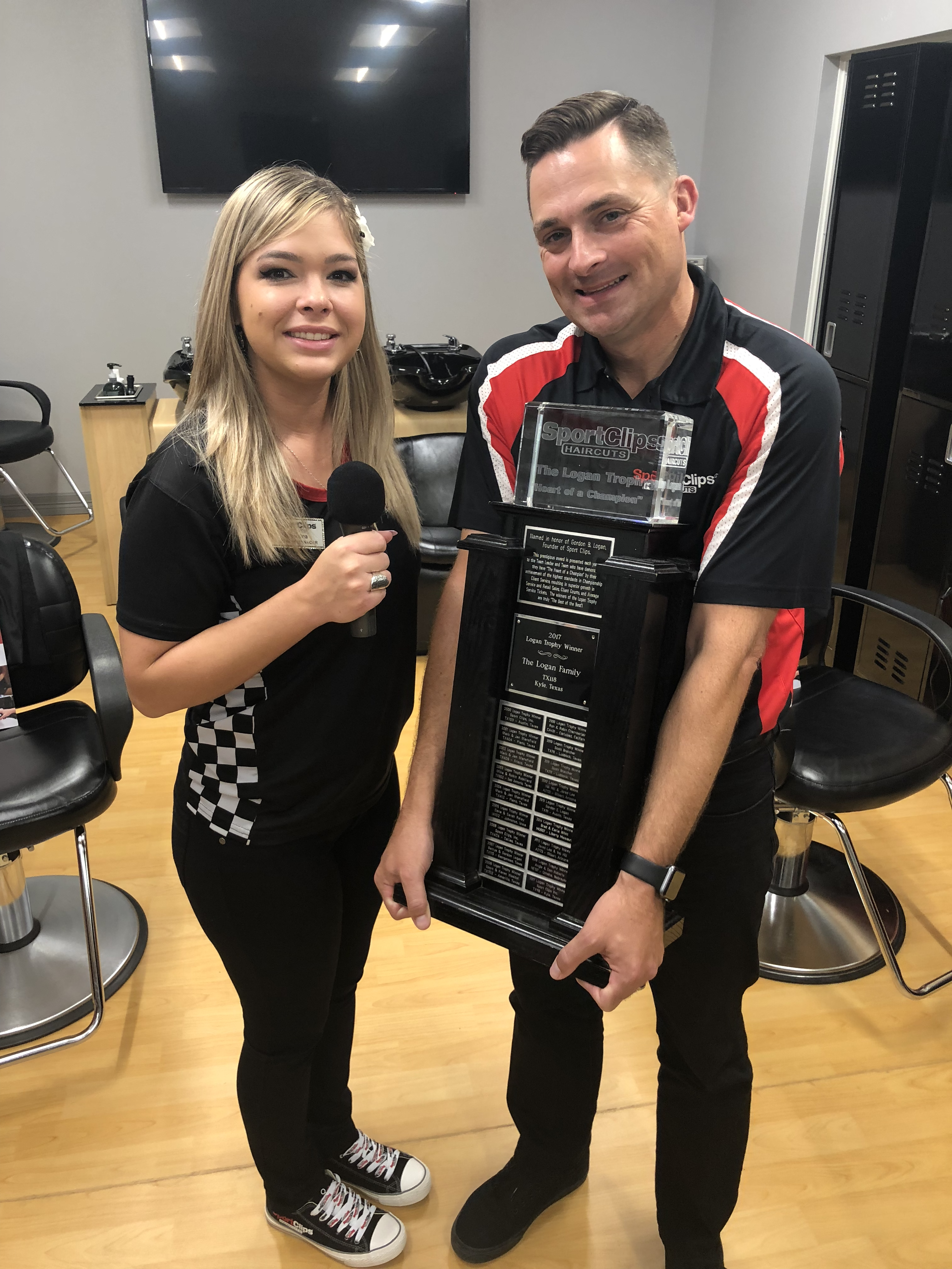 Christina and Chad holding the Logan Trophy.png