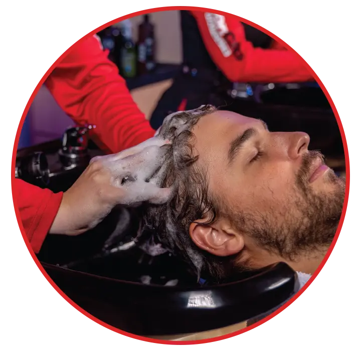 Sport Clips client receiving a massaging shampoo