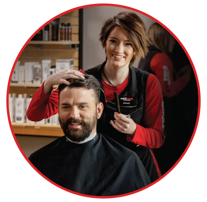 Sport Clips stylist cutting customers hair